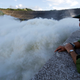 A soldier watches as Hoa Binh hydroelectric power plant opens its flood gates.